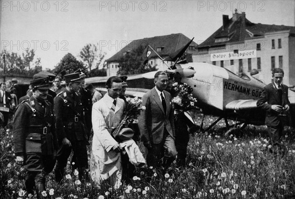 Joseph Goebbels, Center Foreground, Wearing White Trench coat and Holding Flowers, at Konigsberg Airport, East Prussia, 1933