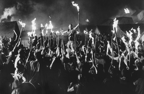 Kirk Douglas and Crowd at Night, on-set of Film, "Spartacus", 1960