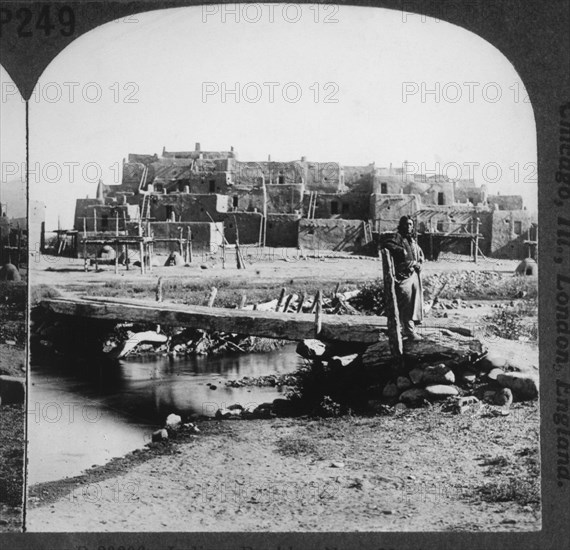 Native American Standing on Bridge near Adobe Village, Taos, New Mexico, USA, Single Image of Stereo Card, circa 1900