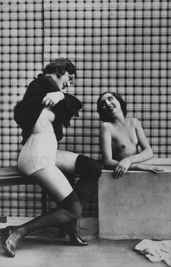 Two Women, One Seated and Disrobing, the Other Nude in Bathtub, 1925