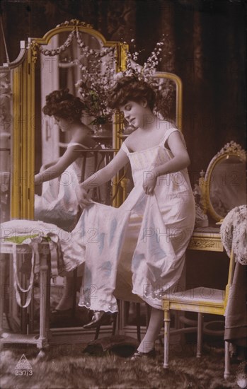 Lingerie Model Standing Near Mirror, circa 1920