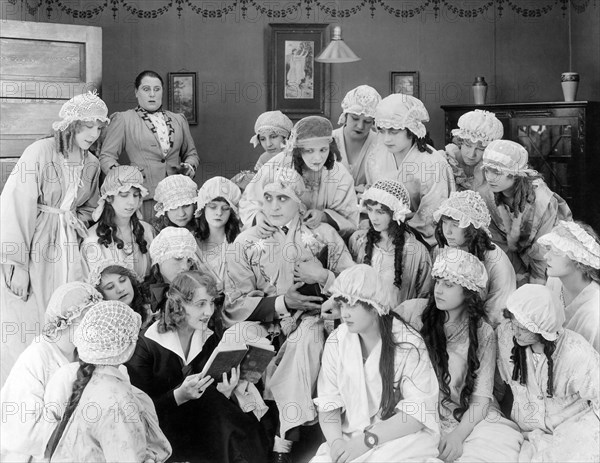 George Walsh (Center), Doris Pawn (reading), on-set of the Silent Film, "The Book Agent", 20th Century Fox, 1917