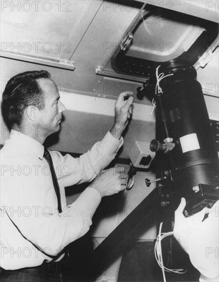 NASA Astronaut Scott Carpenter Inspecting Equipment in Advance of his Journey to View Sun's Corona During Total Eclipse over South Pacific, May, 24, 1965