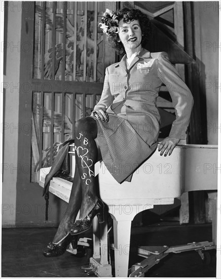 Woman in Skirt Wearing Dark Makeup on Legs (with additional romantic message) due to Shortage of Silk and Nylon Stockings during World War II, USA, 1943