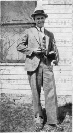 John Dillinger (1903-1934), American Gangster, Portrait holding Toy Gun Used to Escape Jail in Crown Point, Indiana, USA, 1934