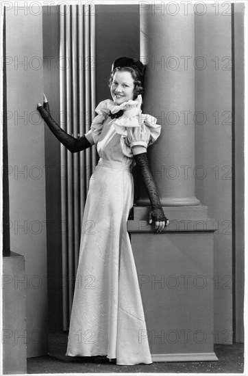 Fashionable Woman in Long Gown with Ruffled Sleeves and Collar and Elbow-Length Gloves, Portrait, circa 1921