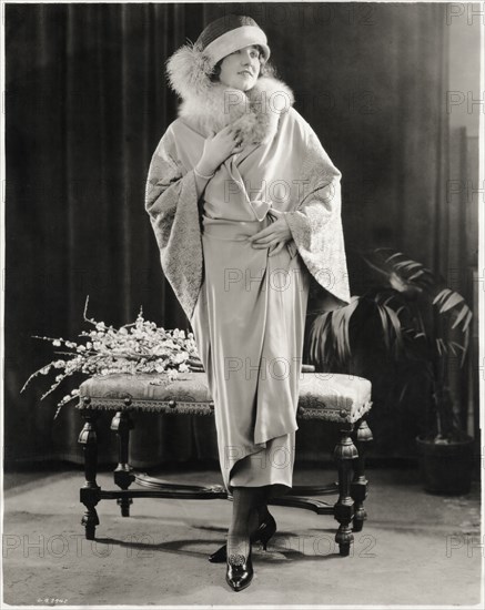 Fashionable Woman in Long Wrap-Dress of Canton Crepe with Fox Fur Collar and Embroidered Sleeves, with Hat, Portrait, circa 1923