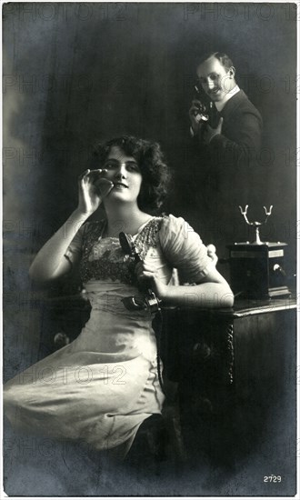 Woman Holding Telephone Receiver with Man Talking on Telephone in Background, French Postcard