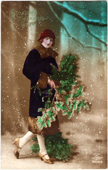 Smiling Woman in Red Hat and Blue Coat Holding Green Boughs, Hand-Colored Christmas Postcard, circa 1920's