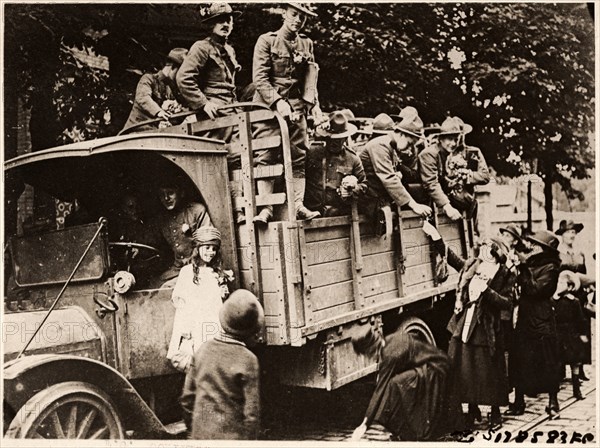 French Women giving Flowers to American Soldiers Heading to the Front, Paris, France, circa 1918