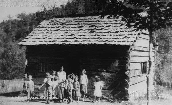 Teacher and Students Standing in front of Log Cabin Mountain School, USA, circa 1910