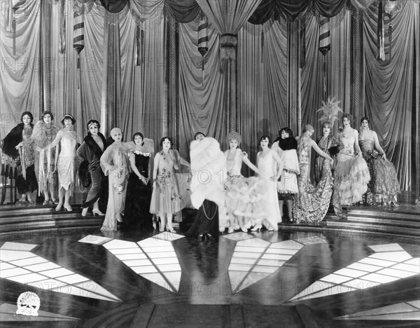 Mildred Harris (2nd from left), Olive Borden (6th from left), Leatrice Joy (center), Sally Rand (7th from right), on-set of the Silent Film, "The Dressmaker from Paris", 1925