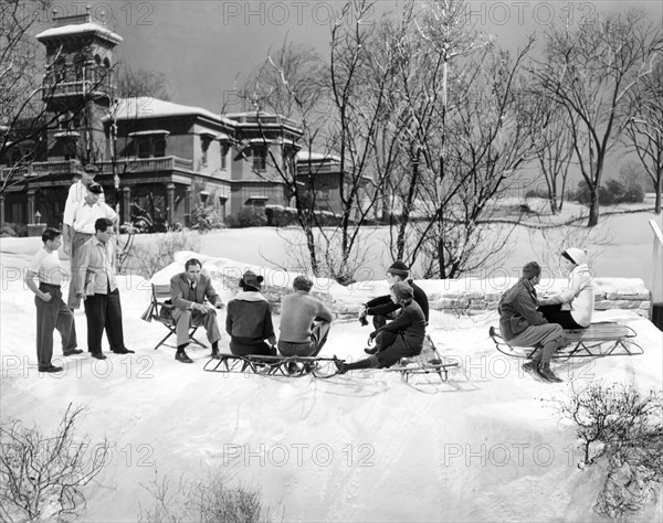 Director King Vidor, (seated, left), and cast prepare for snowball fight, on-set of the Film "H.M. Pulham, Esq.", 1941