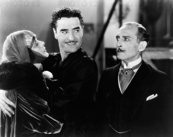 Alma Rubens, John Gilbert, Frank Reicher, on-set of the Silent Film "The Masks of the Devil", 1928