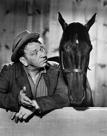 Wallace Beery with Maiden Brave, on-set of the Film "Stable Mates", 1934