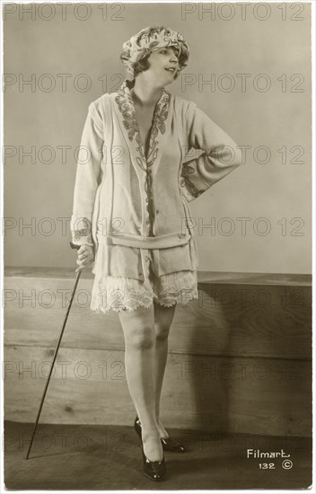 Portrait of Fashionable Woman in Short Skirt and Leaning on Cane, French Postcard, circa 1930