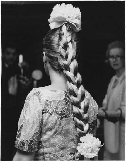 Woman with Fashionable Long Braid Entwined with Ribbon and Large Flowers Decorating the Crown and End of Braid, 1965