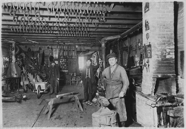 Blacksmith in Cartwright shop, circa 1890