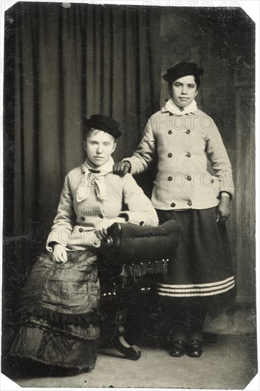Portrait of Two Adult Women, One Seated, One Standing, with Matching Hats and Jackets, circa 1870