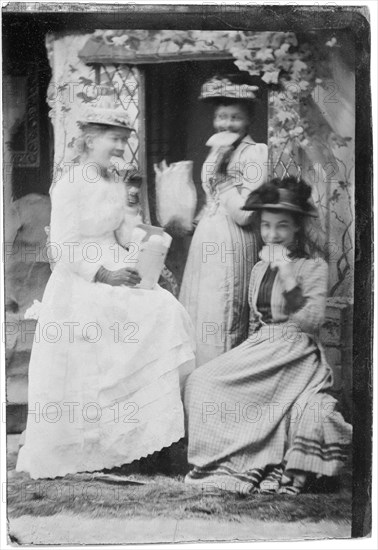 Portrait of Three Smiling Adult Women with Large Crackers in Mouths, circa 1870