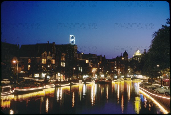 Illuminated Houseboats along Canal at Night, Amsterdam, Netherlands, 1963