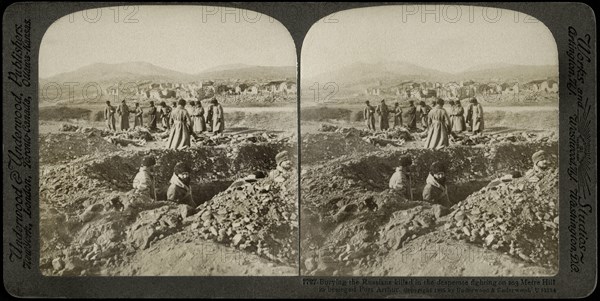 Burying the Russians killed in the desperate fighting on 203 Metre Hill in Besieged Port Arthur, Stereo Card, Underwood & Underwood, 1905