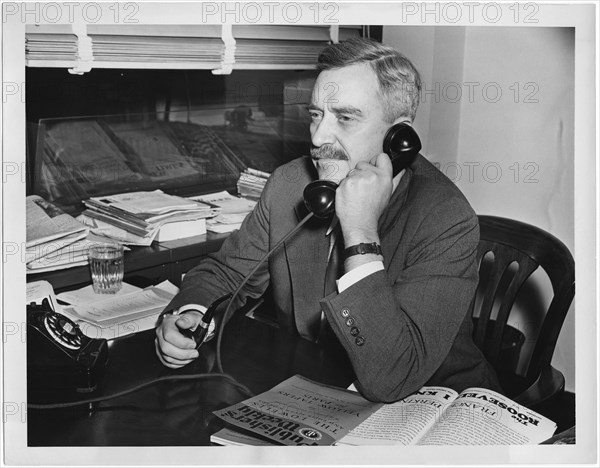 Earl Browder, former Communist Party General Secretary in the U.S., starting new job as Representative for Soviet Publishers, which has become an Object of Interest by the U.S. State Department, Portrait on Telephone in his Office, New York City, New York, USA, July 16, 1946