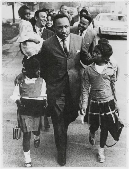 Martin Luther King Jr. Escorting Schoolchildren to Newly Integrated School, Andrew Young, Joan Baez and Hosea Williams in Background, Grenada, Mississippi, USA, September 20, 1966