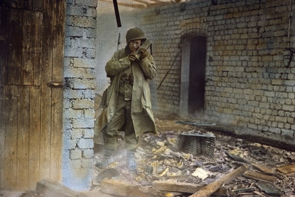 Infantryman Armed with a Carbine Equipped with Grenade Launcher Using Handie-Talkie Radio, Rhineland Campaign, Germany, 1945