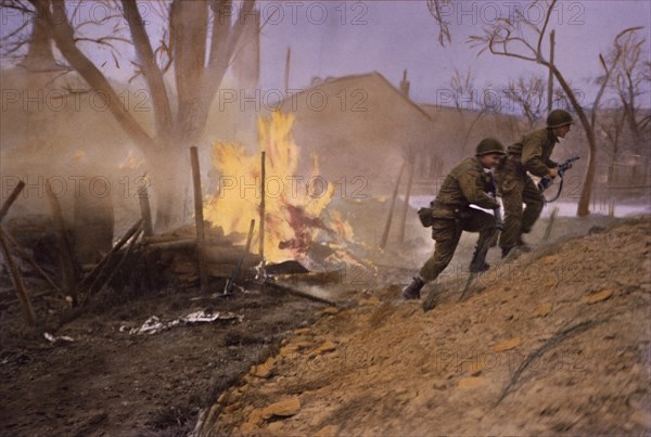 Infantrymen Moving Past Fire Started by Enemy Shelling, Rhineland Campaign, Germany, 1945