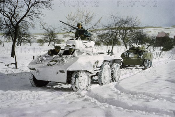 Camouflaged Light Armored Car M8 and one that was not Painted White, Ardennes-Alsace Campaign, Battle of the Bulge, 1945