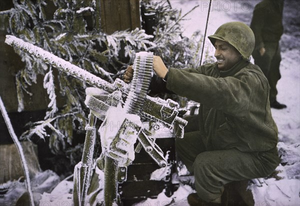 Member of Cavalry Reconnaissance Squadron Checks .30-caliber Machine Gun, Ardennes-Alsace Campaign, Battle of the Bulge, 1945