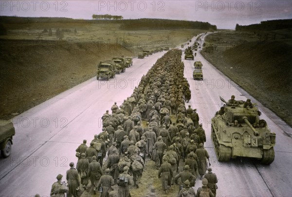 Armored Troops Moving to the Front as Prisoners are Marched along Autobahn to the Rear, Central Europe Campaign, Western Allied Invasion of Germany, 1945