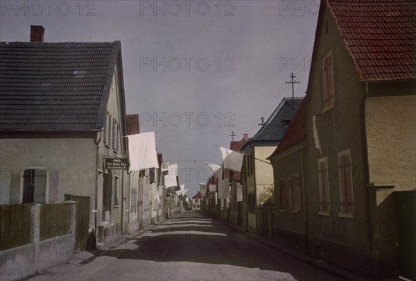 White Flags of Surrender Hang from Buildings in Deserted Street of German Town, Central Europe Campaign, Western Allied Invasion of Germany, 1945