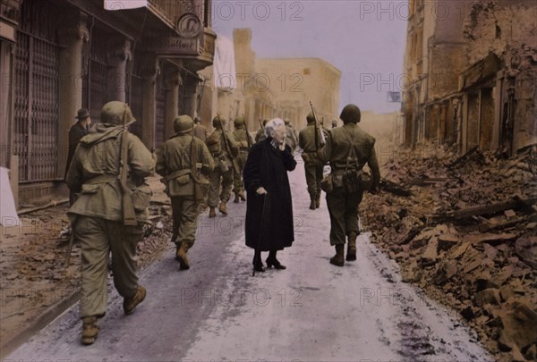 Infantry Troops Marching Through Town, Elderly Woman Looking at Demolished Buildings, Central Europe Campaign, Western Allied Invasion of Germany, 1945