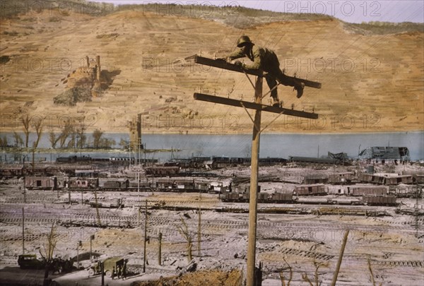 Lineman of Signal Corps Construction Battalion Fastening Wire to Insulator, Bingen on the Rhine, Germany, Central Europe Campaign, Western Allied Invasion of Germany, 1945