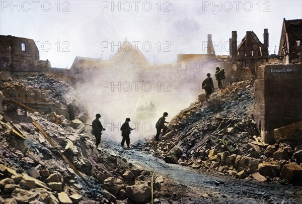 Infantrymen Climbing over Rubble as they Clear Snipers, Nuremberg, Germany, Central Europe Campaign, Western Allied Invasion of Germany, 1945