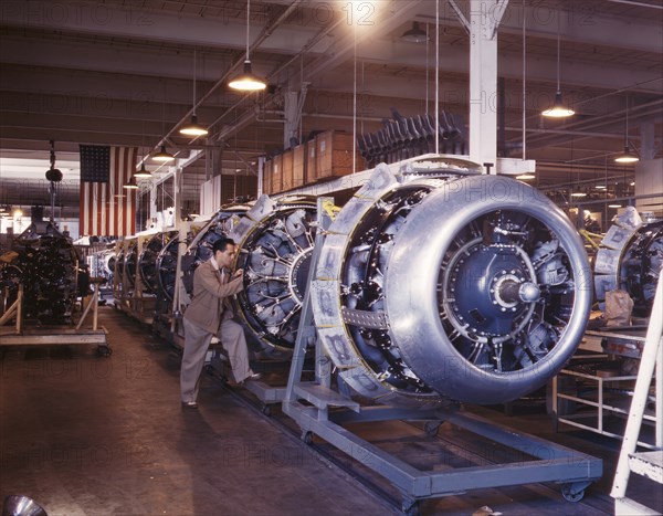 Cowling and Control Rods being added to Motors of B-25 Bombers as they Move Down Assembly Line, North American Aviation, Inc., Inglewood, California, USA, Alfred T Palmer for Office of War Information, October 1942