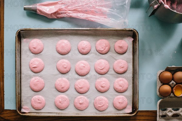 High Angle View of Pink Cookies on Baking Sheet Waiting to be Baked