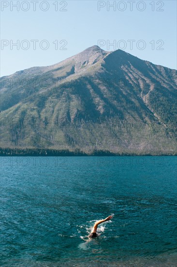 Man Swimming in Mountain Lake