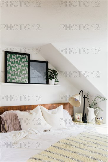 Bed with White Linens and Colorful Artwork