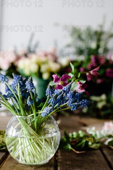 Purple Flowers in Round Glass  Vase