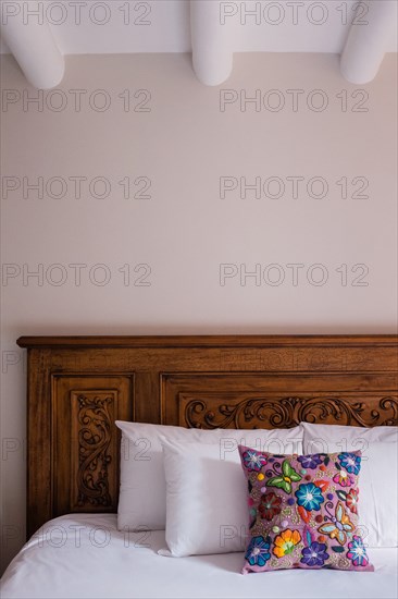 Flowered Pillow on Wood Bed