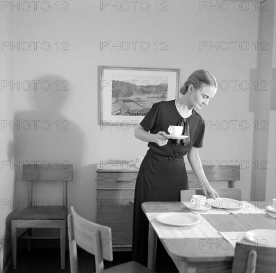 Woman Setting Table, Interior of Completed House, New Deal Cooperative Community, Greenbelt, Maryland, USA, Arthur Rothstein, Farm Security Administration, November 1936