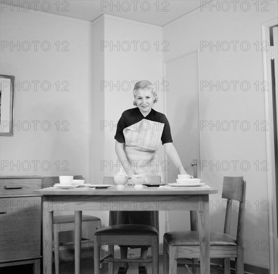 Woman Setting Table, Interior of Completed House, New Deal Cooperative Community, Greenbelt, Maryland, USA, Arthur Rothstein, Farm Security Administration, November 1936