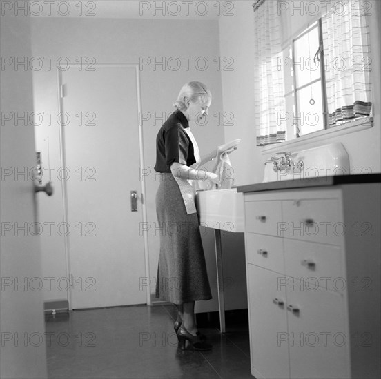 Woman Washing Dishes, Interior of Completed House, New Deal Cooperative Community, Greenbelt, Maryland, USA, Arthur Rothstein, Farm Security Administration, November 1936