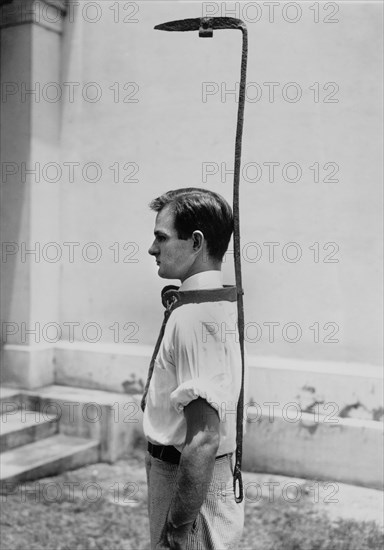 Richbourg Gailliard, assistant to the director of the Federal Museum, Demonstrates the use of a Bell Rack, a Contraption used by Slave Owners to guard a Runaway Slave, originally topped by a bell, which rang when the runaway would attempt to leave the road and go through foliage or trees, Mobile, Alabama, USA, 1936