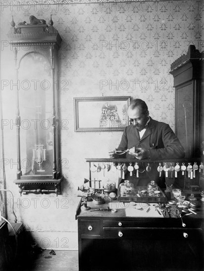 Mr. Dodson, Jeweler, Standing Behind Display of Watches, Examining a Pocket Watch, Nashville, Tennessee, USA, W.E.B. DuBois Collection, 1899