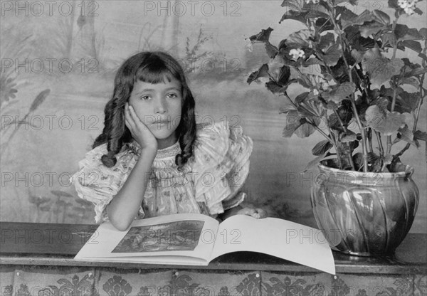 Daughter of Thomas E. Askew, Head and Shoulders Portrait, Seated, Right Hand on Cheek with Open Book, Atlanta, Georgia, USA, Thomas E. Askew, W.E.B. DuBois collection, 1900