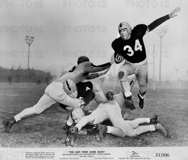 Actor Paul Douglas (with football), on-set of the Film, "The Guy who Came Back", 20th Century Fox, 1951